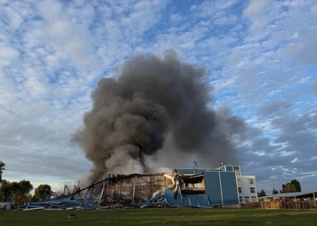 Black smoke billowing from warehouse blaze after Russian attack.